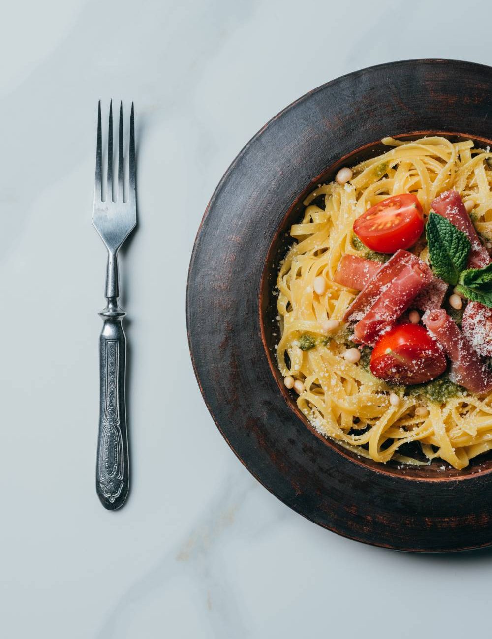 elevated-view-of-pasta-with-mint-leaves-jamon-and-2026-03-25-10-55-12-utc (1)